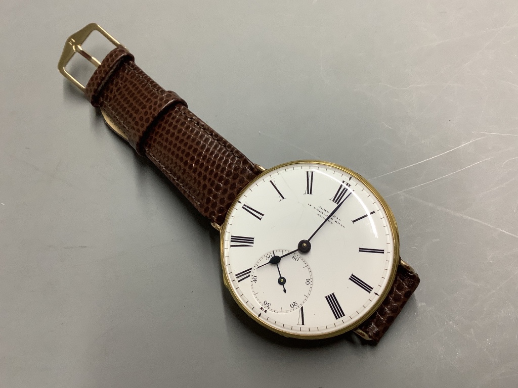 An early 20th century continental yellow metal open face pocket watch, converted to a wrist watch (a.f.)